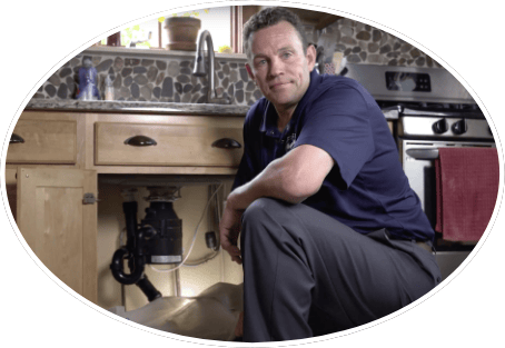 Plumber in front of sink, representing career opportunities with Vaughan Comfort Services.
